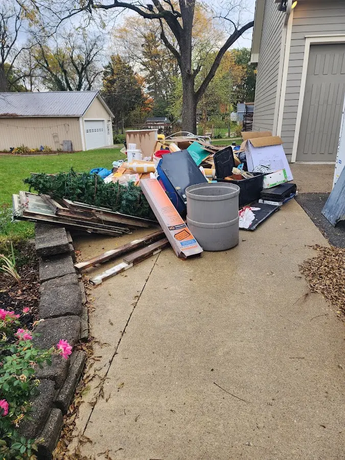 Dumpster being loaded with debris for Estate Cleanout Dumpster Rental in Mount Healthy